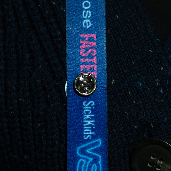 A lanyard with a blue strap and a pin clip.