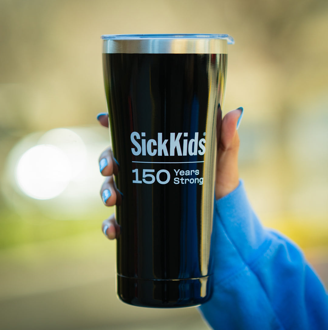 A hand holding a black stainless steel travel mug with 'SickKids 150 Years Strong' printed on the side.