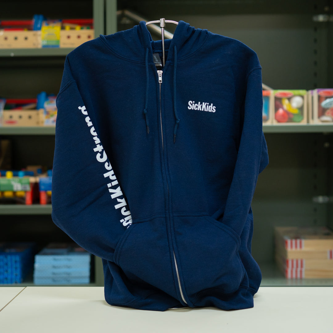A navy blue SickKids full-zip hoodie with the brand's name on the front and sleeve, displayed on a stand.