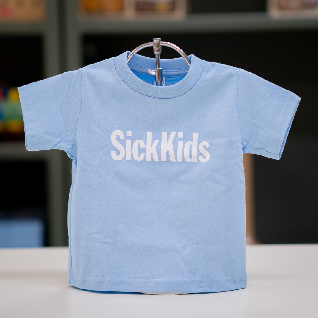 A light blue toddler T-shirt with the SickKids logo printed in the center.