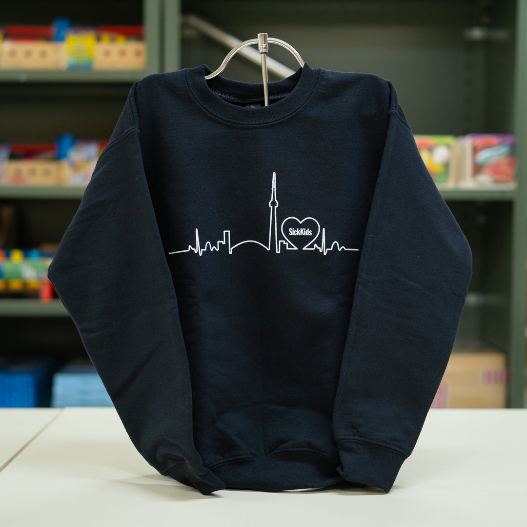 Youth crewneck sweater in black with a skyline design on the front.