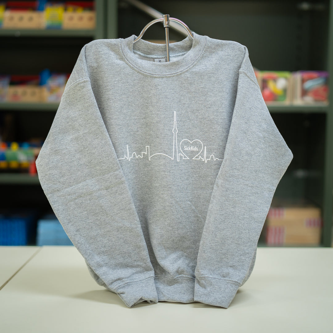 Youth crewneck sweater in gray color with a skyline graphic on the front.