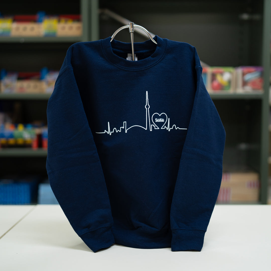 A navy blue youth crewneck sweater with a white skyline print on the front.