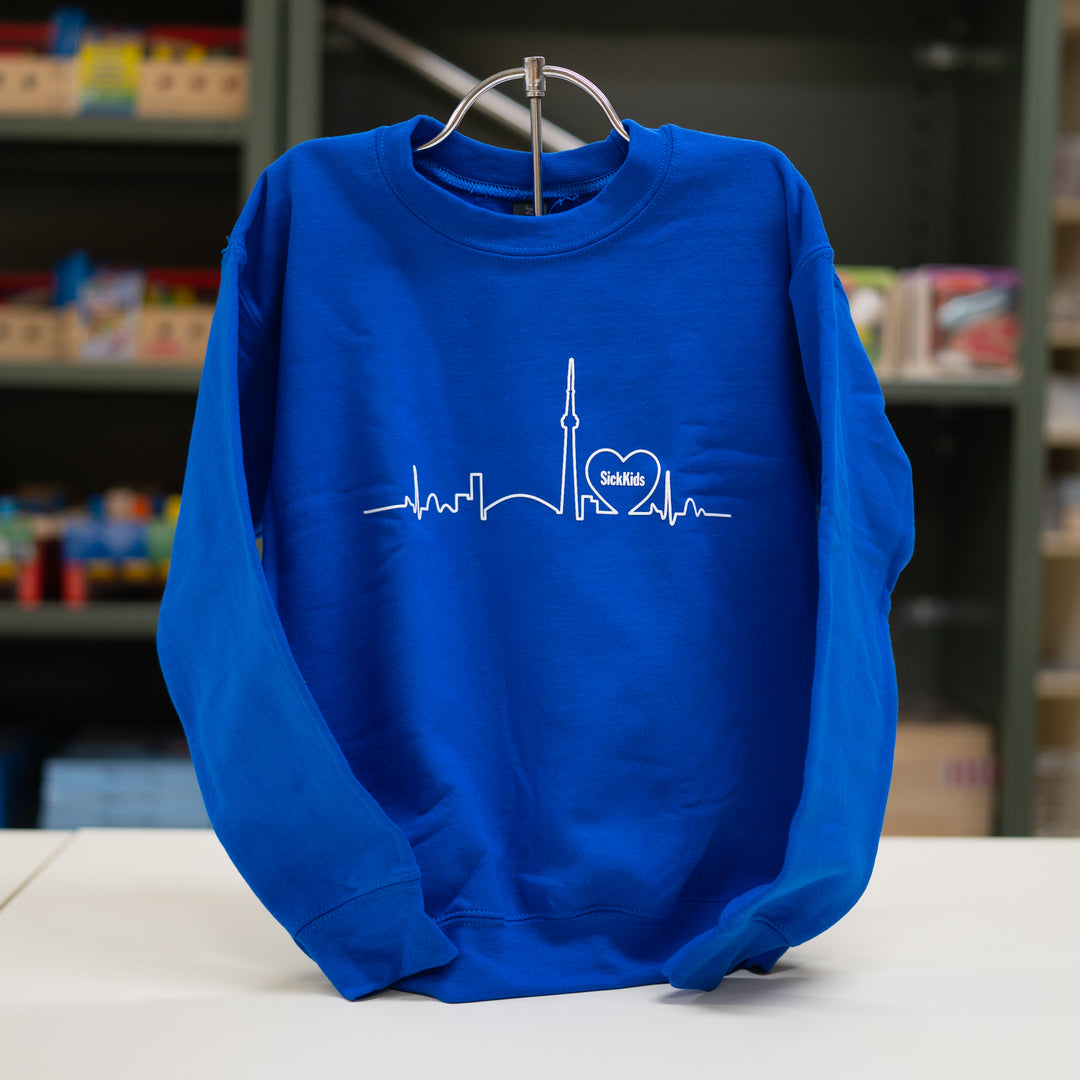 A blue youth crewneck sweater with a white skyline print on the front.