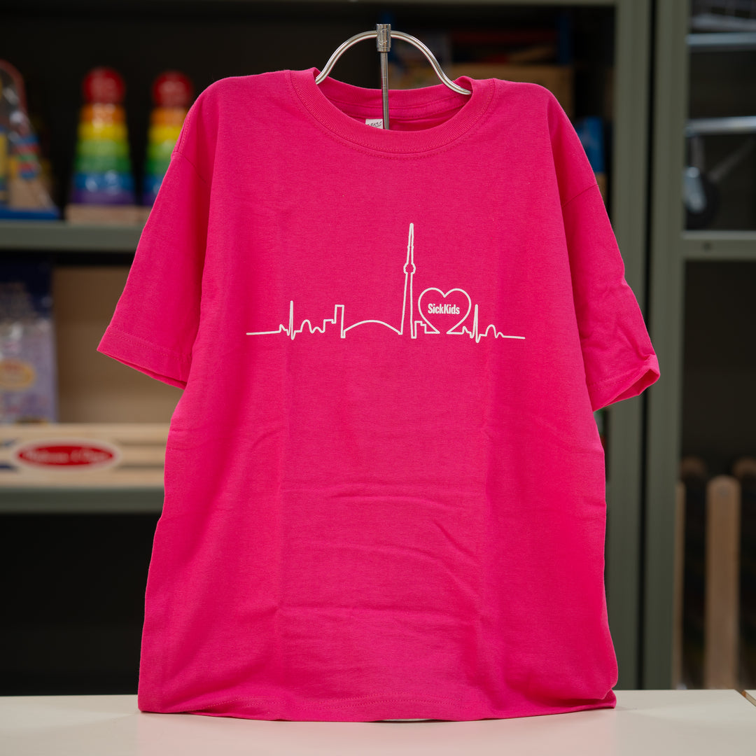 Pink t-shirt with a white graphic design on a hanger